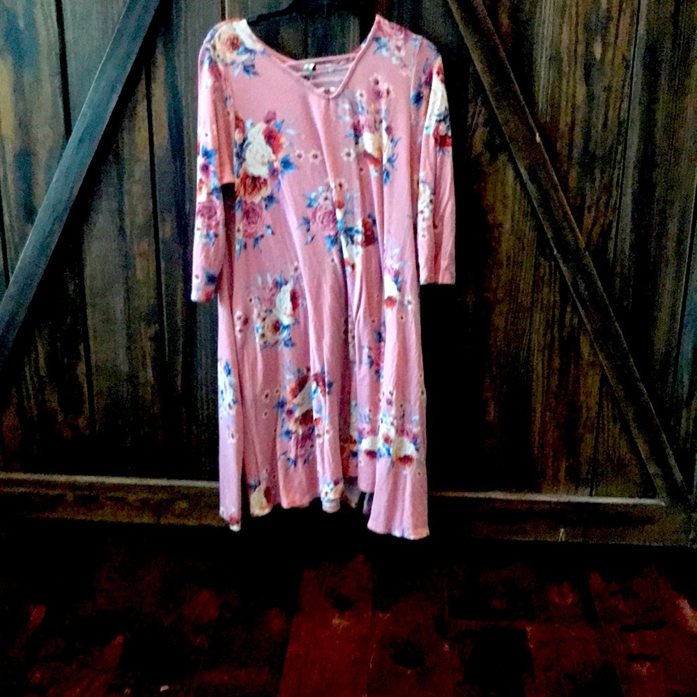 A pink dress with floral designs